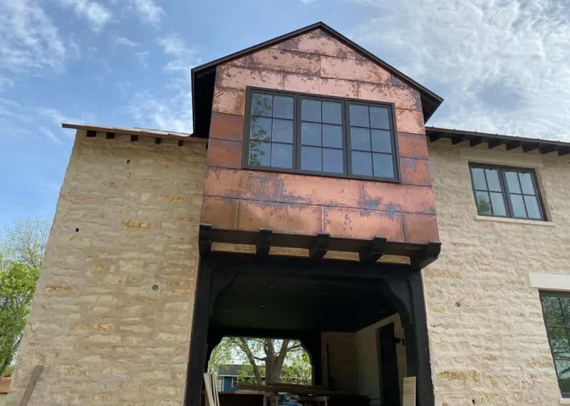Copper metal panel facade on a stone building for Roof Repair in Glendale Heights